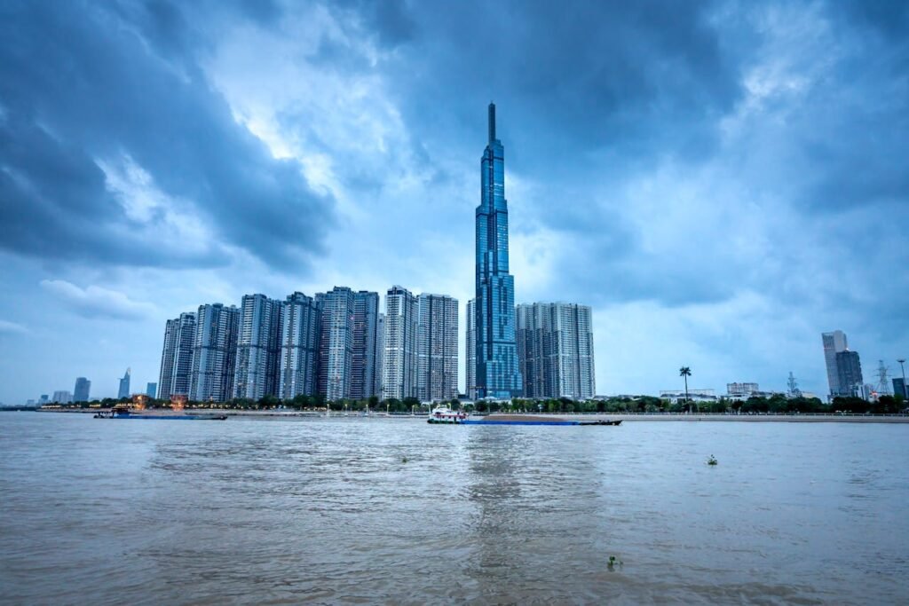pexels-photo-6128392 Breathtaking view of Ho Chi Minh City in Vietnam with skyscrapers near trees and Landmark 81 building near river with ships under cloudy sky in daytime